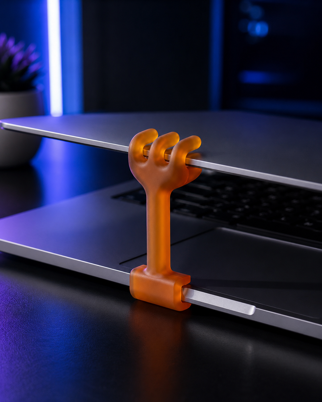 The hand holding a laptop open while it keeps working